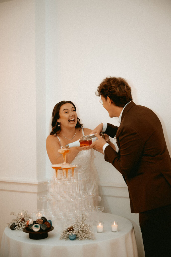 romantic couple moment doing a champagne tower at their pittsburgh wedding reception