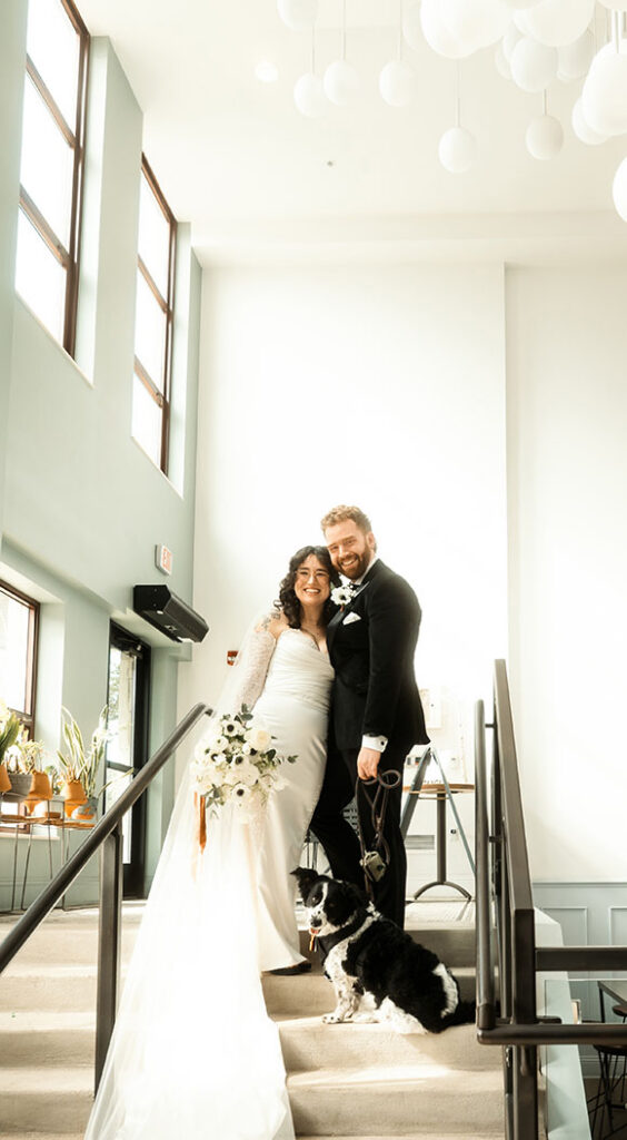Emotional wedding photos with dog walking with couple during portraits in Pittsburgh
