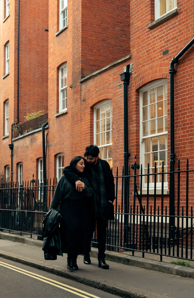 Couple embracing beside elegant architecture in Mayfair London