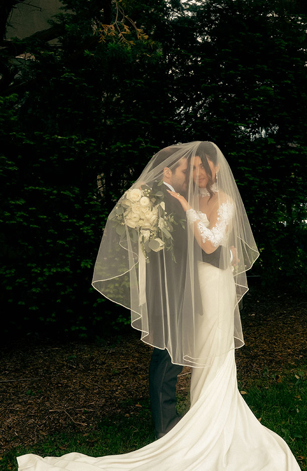 Fine art bridal portrait with soft natural light and flowing wedding dress.