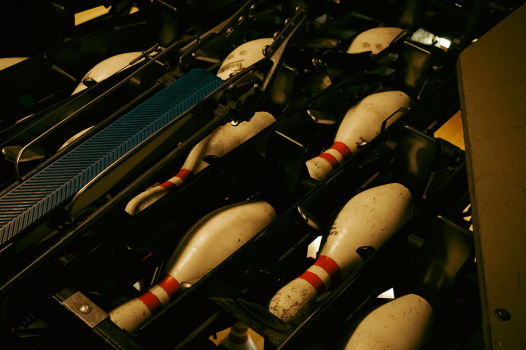 Industrial machinery operating behind Arsenal Bowl bowling lanes
