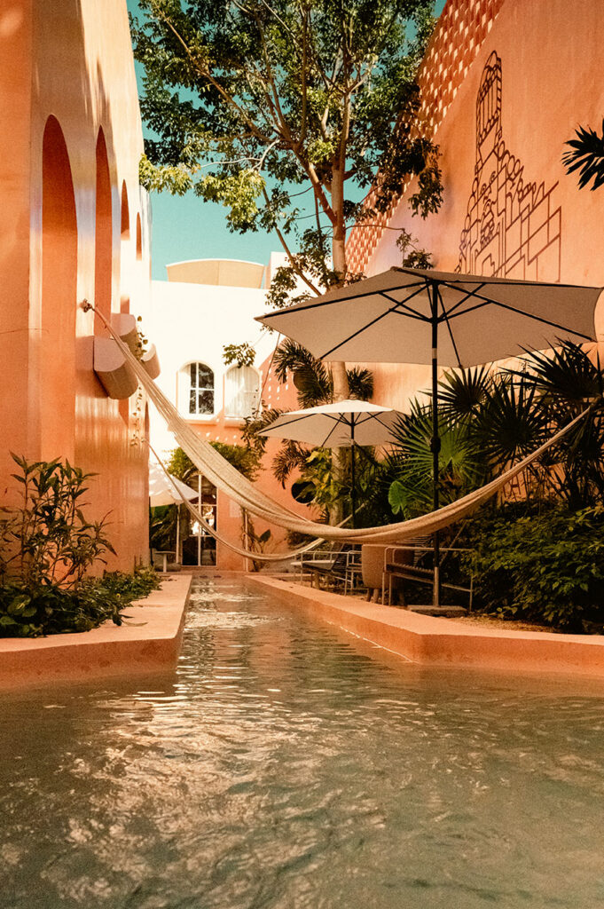 Quiet courtyard at Casa Amate surrounded by pink walls and tropical greenery