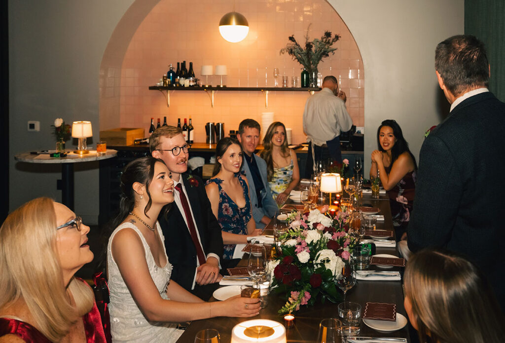 Newlyweds sharing a quiet moment at their seats during the intimate Balvanera reception.