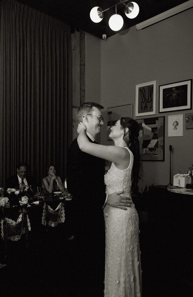 Bride and groom smiling at one another during their first dance at Balvanera.