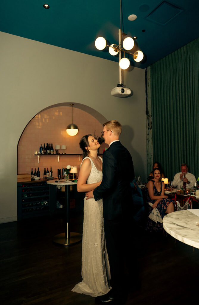 Newlyweds sharing a quiet moment at their seats during the intimate Balvanera reception.
